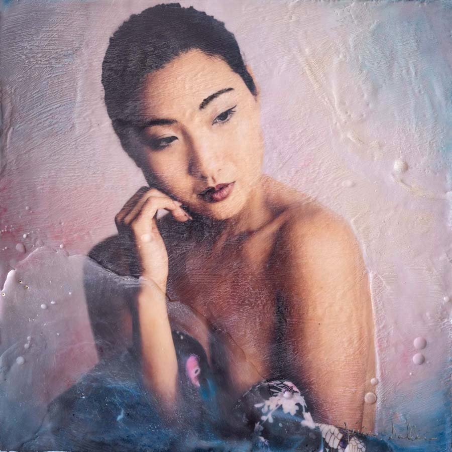 Mixed media fine art portrait of a woman in soft pinks and blues, with an introspective expression, created by Jerome Art Photography.