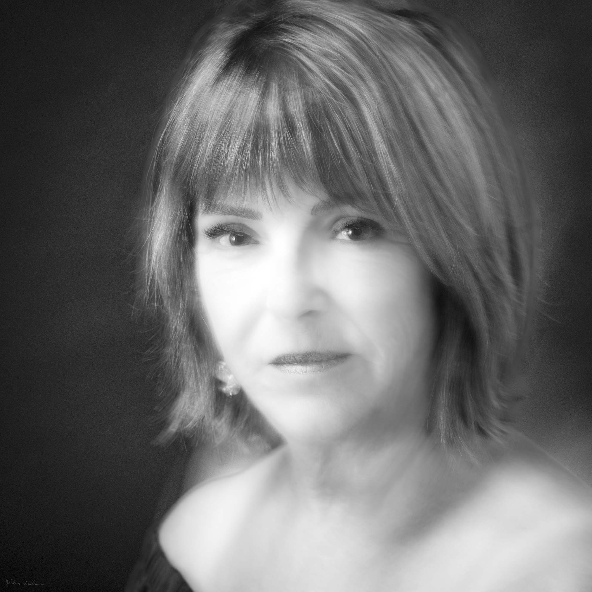 Soft-focus black-and-white portrait of a mature woman with short hair and a gentle expression, by Jerome Art Photography.